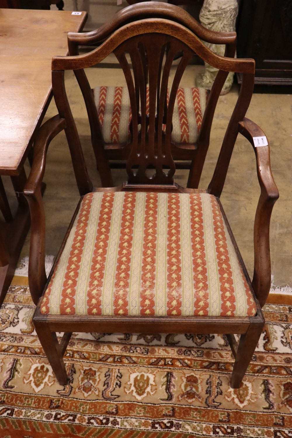 A set of four Hepplewhite style dining chairs (3 single, 1 arm) and four Edwardian dining chairs